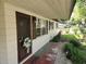 Front porch with decorative wreath on the door and manicured landscaping at 220 Pinehurst Dr, Auburndale, FL 33823