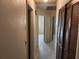 Hallway with tile flooring, doors, and access to rooms; bright neutral tones at 220 Pinehurst Dr, Auburndale, FL 33823