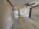Spacious living room with neutral colored walls, tile flooring, and a ceiling fan at 220 Pinehurst Dr, Auburndale, FL 33823