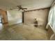 Neutral living room featuring tile flooring, ceiling fan and natural lighting at 220 Pinehurst Dr, Auburndale, FL 33823