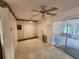 Spacious living room with neutral colored walls, tile flooring, and a ceiling fan at 220 Pinehurst Dr, Auburndale, FL 33823