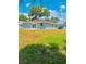 Exterior shot of a house with a yard, showcasing the backyard space and neighboring properties at 2220 W Lanier St, Lakeland, FL 33815