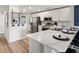Modern kitchen with stainless steel appliances, a marble countertop, and sleek white cabinets at 230 Turtle Bay Ave, Winter Haven, FL 33881