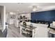 Open-concept living space with modern furniture and a kitchen featuring a central island at 230 Turtle Bay Ave, Winter Haven, FL 33881