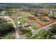 Wide-angle property view, highlighting a house set amid a spacious lot with mature trees at 2323 State Road 33, Clermont, FL 34714
