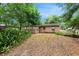 The backyard offers a serene outdoor space with mature trees at 236 Hillside Dr, Lakeland, FL 33803
