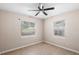 Bedroom featuring neutral walls, tiled flooring, ceiling fan, and natural light from two windows at 236 Hillside Dr, Lakeland, FL 33803