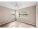 Bedroom featuring neutral walls, tiled flooring, ceiling fan, and natural light from two windows at 236 Hillside Dr, Lakeland, FL 33803