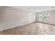 Bright living room featuring neutral walls, tiled flooring, and a sunlit window at 236 Hillside Dr, Lakeland, FL 33803