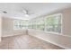 Enclosed sun room with ceiling fan and multiple windows allowing natural light at 236 Hillside Dr, Lakeland, FL 33803