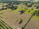 Aerial view of the property showcasing the house, surrounding land and vegetation at 2500 Brooke Rd, Fort Meade, FL 33841
