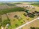 Wide aerial view displaying expansive property and surrounding landscape with multiple fields and homes at 2500 Brooke Rd, Fort Meade, FL 33841