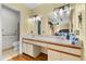 Bathroom featuring a dual sink vanity and a mirror with decorative lighting at 2500 Brooke Rd, Fort Meade, FL 33841