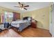 Bedroom featuring wood-look floors, a ceiling fan, and a large window for natural light at 2500 Brooke Rd, Fort Meade, FL 33841
