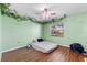 Bedroom featuring plank floors, ceiling fan and view to the outdoors at 2500 Brooke Rd, Fort Meade, FL 33841