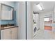 Hallway with bathroom, laundry room, and tile flooring at 2500 Brooke Rd, Fort Meade, FL 33841