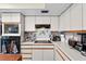 Functional kitchen featuring white cabinets, modern appliances, and a tile backsplash design at 2500 Brooke Rd, Fort Meade, FL 33841