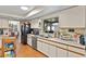 Bright kitchen offers ample storage with wood laminate floors and a view to the dining room at 2500 Brooke Rd, Fort Meade, FL 33841