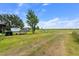 Land featuring a field with grass, scattered trees, blue sky, and some equipment at 2500 Brooke Rd, Fort Meade, FL 33841