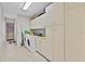 Laundry room with cabinets, washer, dryer, and tile flooring at 2500 Brooke Rd, Fort Meade, FL 33841