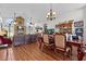 Open living space showcasing wood floors, a fireplace, and a dining area with decorative chandelier at 2500 Brooke Rd, Fort Meade, FL 33841