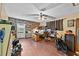 Office area with wood wall, ceiling fan, and wood flooring at 2500 Brooke Rd, Fort Meade, FL 33841