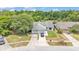 Aerial view of a well-maintained property showcasing a spacious layout, mature trees, and a two-car garage at 2526 Fabry Cir, Orlando, FL 32817