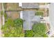 An aerial view of the house shows the layout of the roof, yard with mature trees, and driveway at 2526 Fabry Cir, Orlando, FL 32817