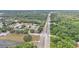 An aerial view shows the residential area surrounded by lush trees and major thoroughfares at 2526 Fabry Cir, Orlando, FL 32817