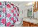 Bathroom with bright lighting, floral shower curtain and modern fixtures at 2526 Fabry Cir, Orlando, FL 32817