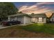 Charming single-story home featuring a two-car garage and well-maintained lawn at sunset at 2526 Fabry Cir, Orlando, FL 32817