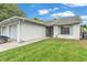 Charming single-story home with a well-maintained lawn, attached two-car garage, and inviting curb appeal at 2526 Fabry Cir, Orlando, FL 32817