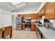Well-lit kitchen with stainless steel appliances, tile floors, and ample counter space at 2526 Fabry Cir, Orlando, FL 32817