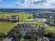 Expansive aerial view showcasing the lush golf course, serene lakes, and beautiful homes within the Grasslands community at 2569 Laurel Glen Dr, Lakeland, FL 33803
