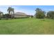 Lush green backyard with well-maintained lawn offers a spacious and private outdoor area for recreation at 2569 Laurel Glen Dr, Lakeland, FL 33803
