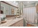 Inviting bathroom with a large mirror, granite countertop vanity, and shower-tub combo at 2569 Laurel Glen Dr, Lakeland, FL 33803