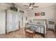 Cozy bedroom features stylish decor, a ceiling fan, and an antique armoire at 2569 Laurel Glen Dr, Lakeland, FL 33803