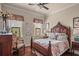 Stylish bedroom features a wood frame bed, decorative windows, and comfortable furniture at 2569 Laurel Glen Dr, Lakeland, FL 33803
