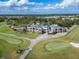 Overhead shot of the community clubhouse set amidst a beautiful golf course and mature trees at 2569 Laurel Glen Dr, Lakeland, FL 33803
