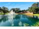 Beautiful entrance to the Grasslands community featuring a fountain lake and serene surroundings at 2569 Laurel Glen Dr, Lakeland, FL 33803