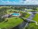 An aerial view of a bridge leading to a stunning community pool near a lake and golf course at 2569 Laurel Glen Dr, Lakeland, FL 33803