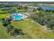 Aerial view of a sparkling community pool with lounge chairs and a lush lawn at 2569 Laurel Glen Dr, Lakeland, FL 33803