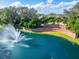Aerial view of Grasslands community entrance featuring a scenic fountain lake and lush landscaping at 2569 Laurel Glen Dr, Lakeland, FL 33803