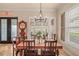 Dining room with a chandelier, windows, and a decorative mirror at 2569 Laurel Glen Dr, Lakeland, FL 33803