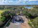 Aerial shot of the Grasslands entrance gate surrounded by beautiful trees with a view of the community at 2569 Laurel Glen Dr, Lakeland, FL 33803
