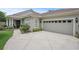Charming home featuring a side-entry garage and lush landscaping at 2569 Laurel Glen Dr, Lakeland, FL 33803
