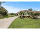 Lush landscaping and a winding driveway complement this attractive single-story home at 2569 Laurel Glen Dr, Lakeland, FL 33803