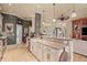 Open kitchen featuring granite countertops, custom cabinets, farmhouse sink, and stainless steel appliances at 2569 Laurel Glen Dr, Lakeland, FL 33803