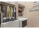 Convenient laundry room with washer, dryer, and upper cabinets offers ample space for laundry tasks and storage at 2569 Laurel Glen Dr, Lakeland, FL 33803