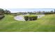 Picturesque pond features manicured hedges and a fountain, enhancing the community's natural beauty at 2569 Laurel Glen Dr, Lakeland, FL 33803